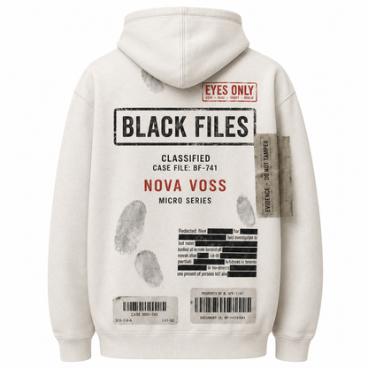Close-up of BLACK FILES hoodie printed fabric barcode patches and classified case file label details.